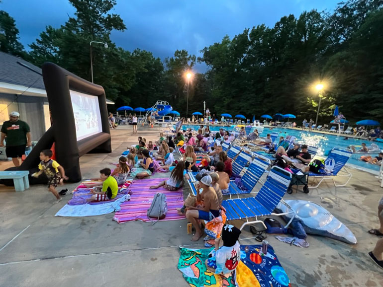 Movie night at Fair Blue, an inflated movie screen is set up on the pool deck