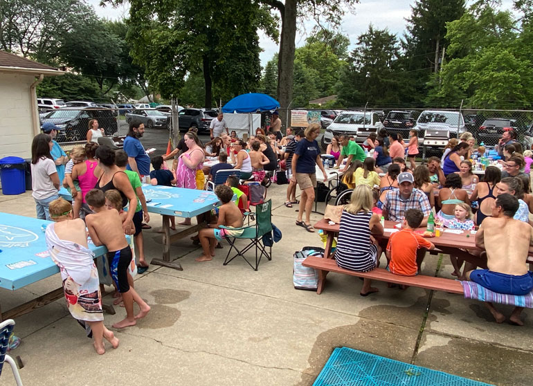 Crowd of people at the snack bar and on the pavilion at Fair Blue Swim Club