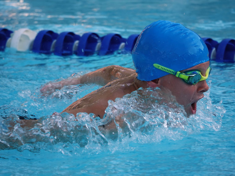 Young swimmer doing the butterfly stroke